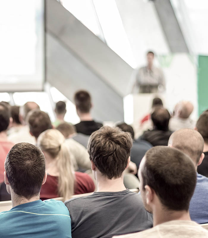 Male speeker having talk at public event.
